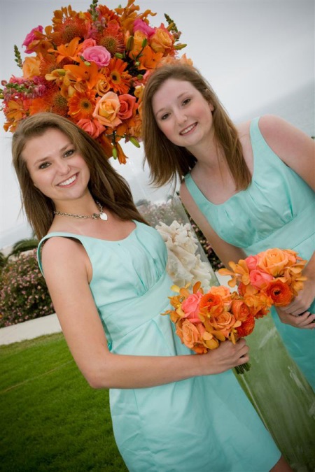 Two honored guests carried petite bouquets of happy orange flowers